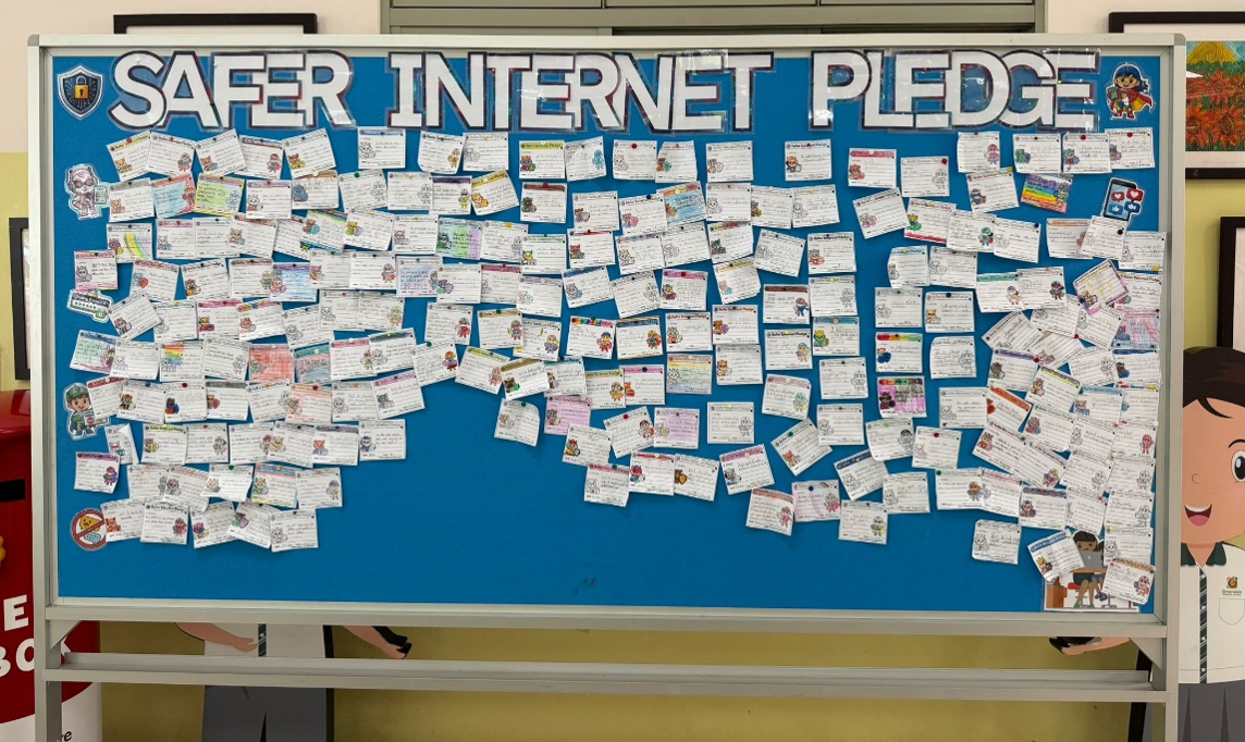 Students completing safer internet pledge activities during a school event.